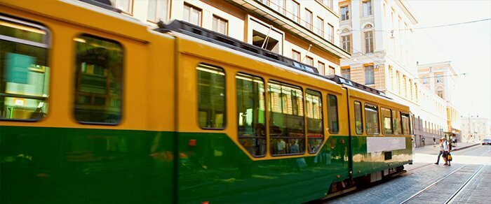 A green and yellow tram in the city centre